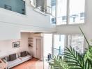 Modern double-height living room with a mezzanine and large windows