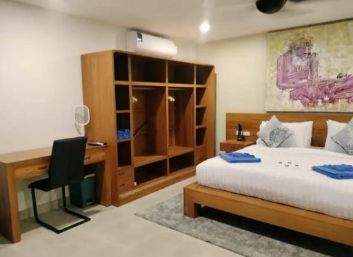 Spacious bedroom with king-size bed and wooden wardrobe