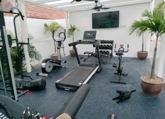 Spacious Home Gym with Variety of Fitness Equipment and Natural Lighting