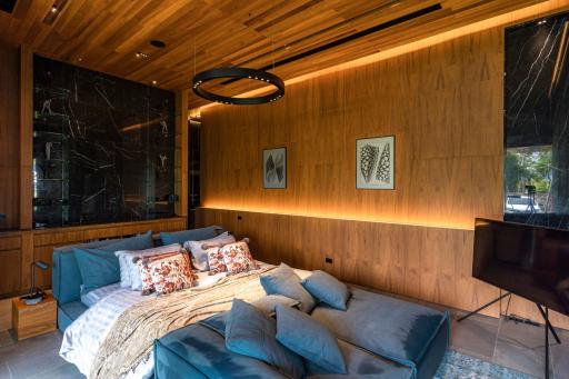 Modern bedroom with wooden paneling and contemporary furnishings