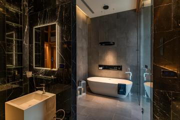Modern bathroom interior with marble tiles and elegant bathtub