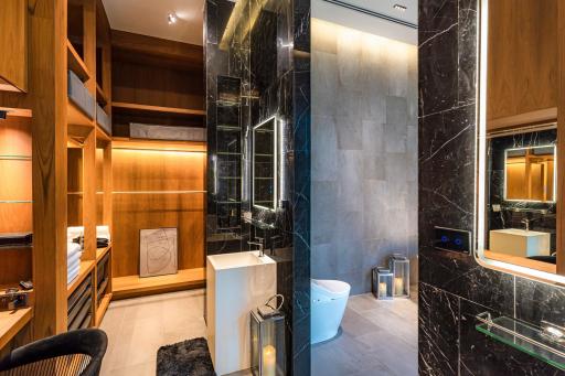 Modern bathroom with marble tiles and wooden accents