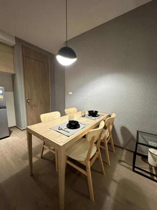 Modern dining area with wooden table and patterned wall