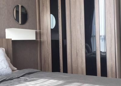 Modern bedroom with a large bed and stylish wooden closet