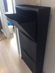 Black shoe cabinet in a residential interior