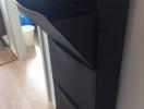 Black shoe cabinet in a residential interior