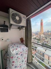 Balcony with city skyline view and air conditioning unit