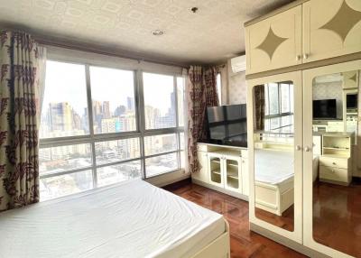Bright and spacious bedroom with large windows and city view