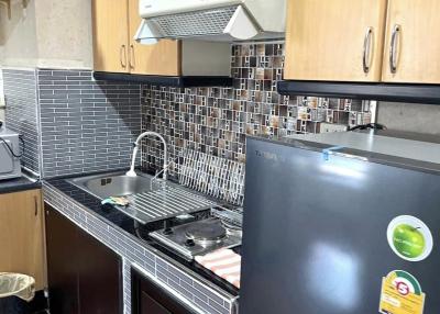 Modern kitchen with stainless steel appliances and wooden cabinets