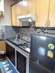 Modern kitchen with stainless steel appliances and wooden cabinets