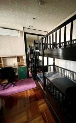 Compact bedroom with bunk beds and a study area