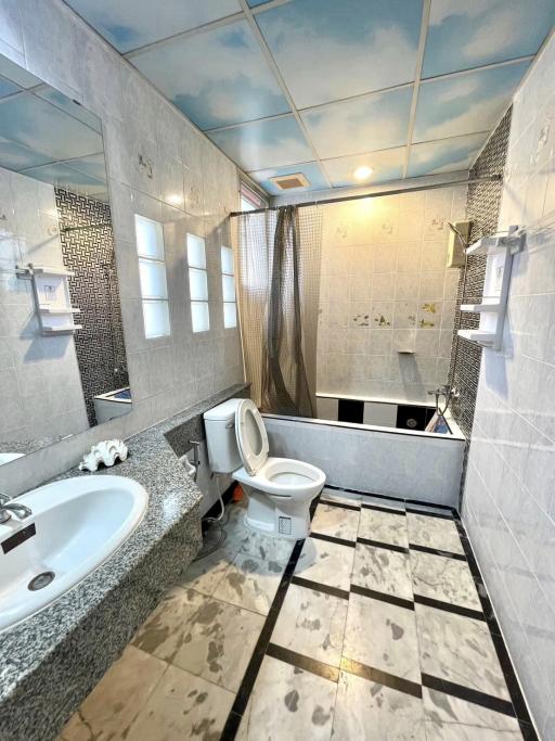 Modern bathroom with bathtub, sink, and toilet