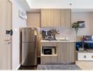 Modern small kitchen with wooden finishes and integrated appliances