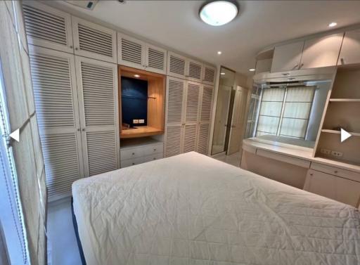 Cozy bedroom with built-in wardrobes and ample lighting