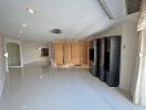 Spacious living room with natural light and modern shelving