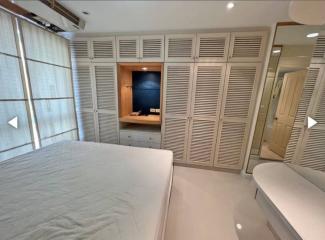 Modern bedroom with built-in closet and work area