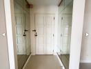 Bright and welcoming entrance hall with mirrors and tiled flooring