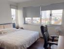 Spacious Bedroom with Large Window and City View