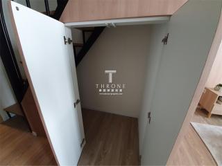 Open empty storage space under stairs in a modern home