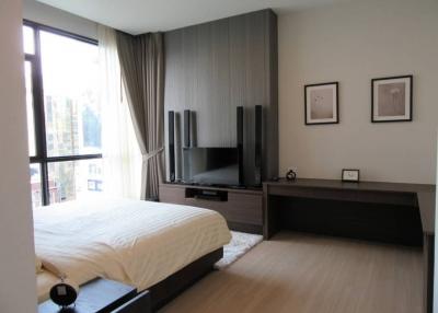 Modern bedroom with large window and city view