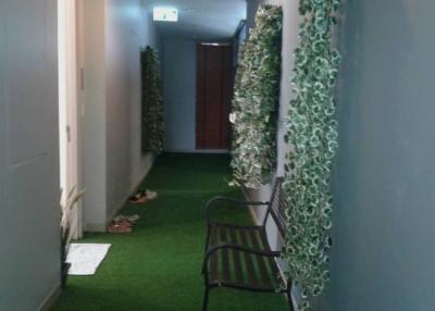 Decorated corridor with artificial greenery and bench