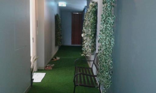 Decorated corridor with artificial greenery and bench