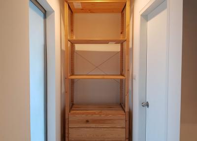 Empty wooden storage shelves in a small room