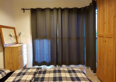 Cozy bedroom with a large bed and dark curtains