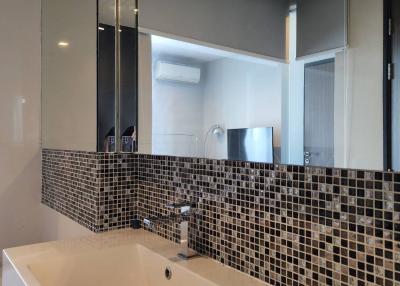 Modern bathroom with large rectangular sink and mosaic tile backsplash