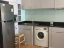 Modern kitchen with stainless steel appliances and hardwood flooring