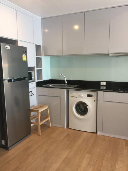 Modern kitchen with stainless steel appliances and hardwood flooring