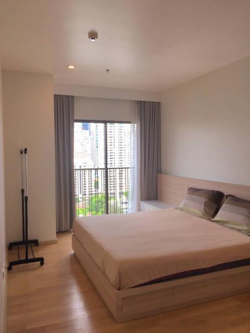 Modern bedroom with a large bed and natural light