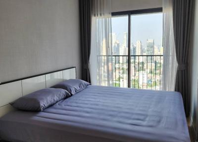 Modern bedroom with large window and city view