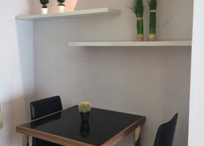 Modern dining area with table, chairs and decorative shelving