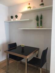 Modern dining area with table, chairs and decorative shelving