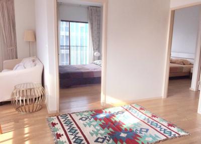 Bright and spacious open living area with view into the bedroom