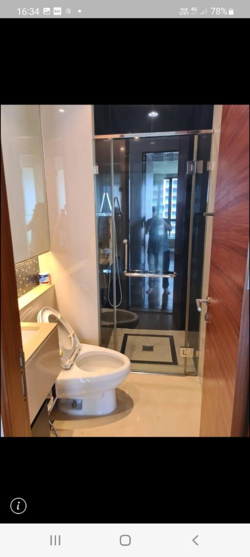 Modern bathroom interior with glass shower and toilet