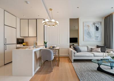 Modern open concept living room with connected kitchen, natural light, and contemporary furnishings