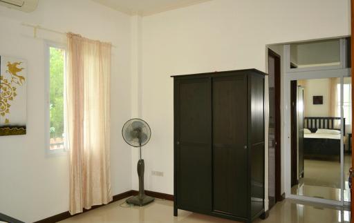 Spacious bedroom with wardrobe and mirror