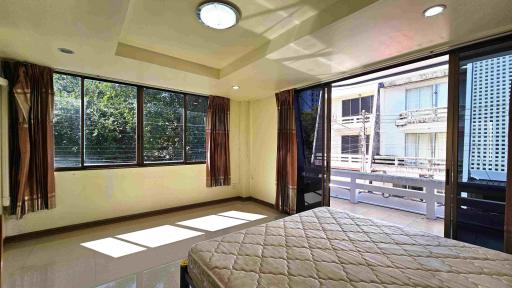 Spacious bedroom with ample natural light and balcony access