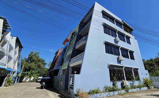 Modern multi-storey building exterior with a clear blue sky