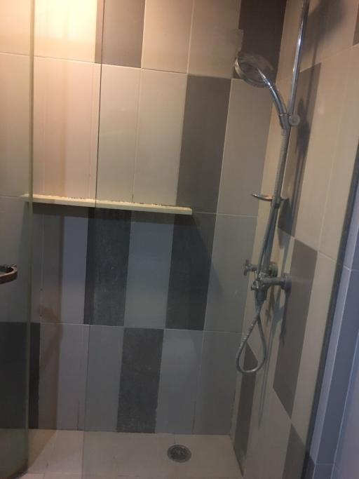 Modern tiled bathroom with shower and glass door