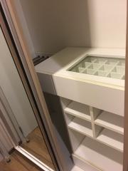 Modern built-in closet interior with shelves and drawers