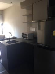 Modern kitchen with stainless steel appliances and floating shelves