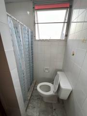 Compact bathroom with shower and toilet