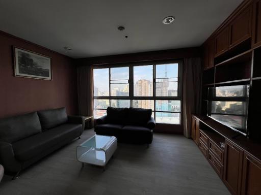 Spacious living room with large windows and city view