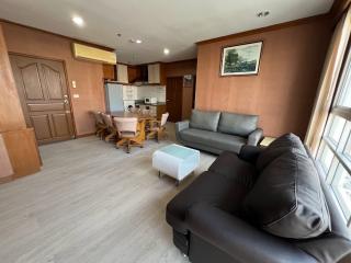 Spacious living room with leather sofa and open-plan kitchen