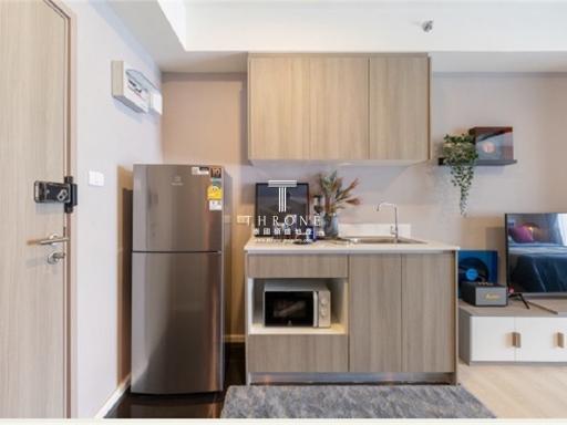 Modern kitchen with wood finishes and stainless steel appliances in a contemporary apartment