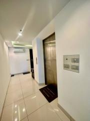 Modern interior building hallway with elevator and tiled flooring