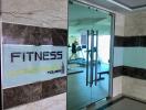 Fitness center entrance with reflection of workout area in Wong Amat Tower